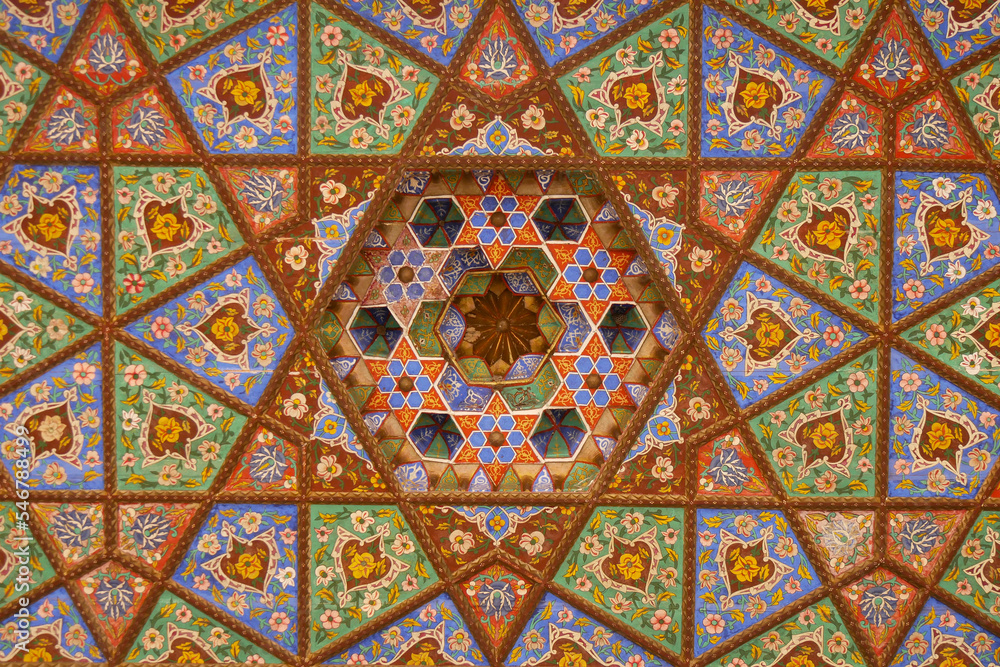 The beautiful painted wooden ceiling in the harem courtyard in Khiva.