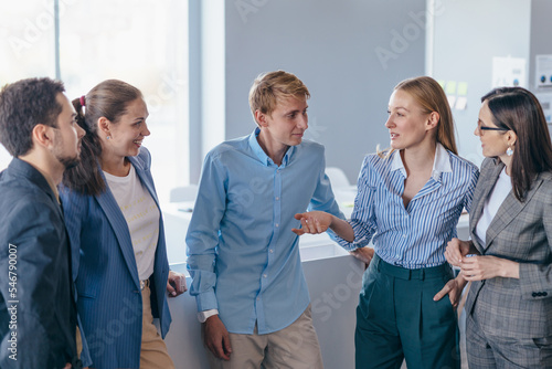 Employees chat informally and lively during the break