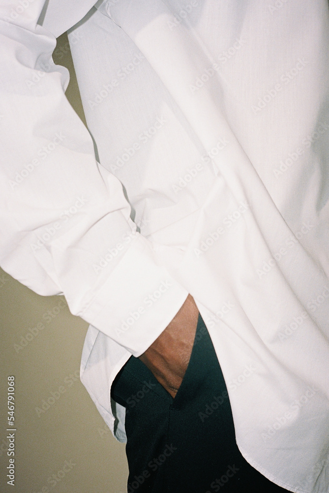 Film photo of a man puts his hands in his pants pockets Photos Adobe