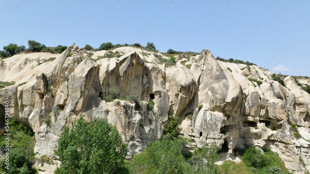 View of ancient cave dwellings carved in stone at Goreme National Park, Cappadocia, Turkey