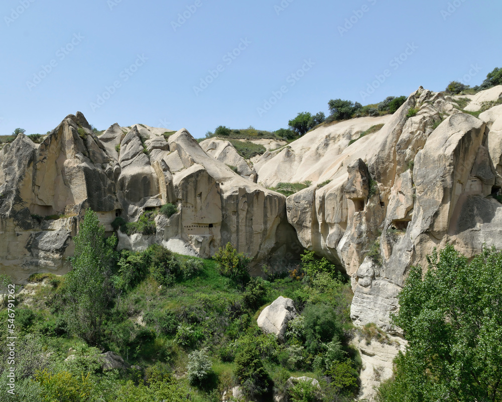 View of ancient cave dwellings carved in stone at Goreme National Park, Cappadocia, Turkey