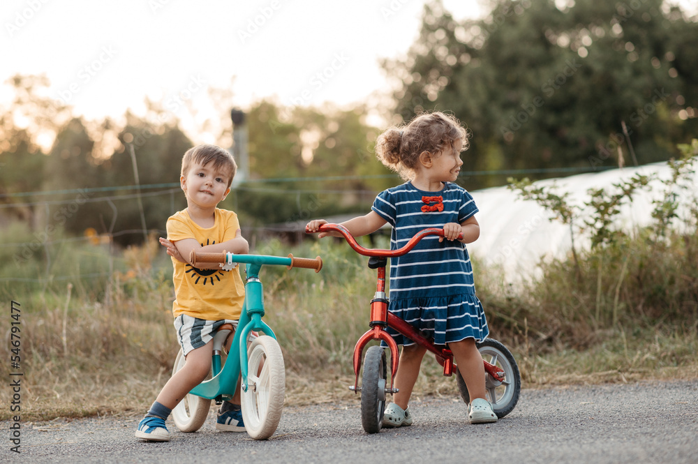 Siblings with bicycles at sunset Siblings with bicycles at sunset