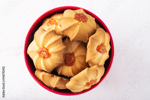 Butter Cookies for Chinese New Year in a red bucket. Sweet shortbread kurabye.