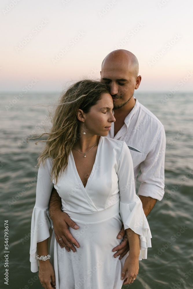 Close up of young couple hugging and kissing in water Close up of young couple hugging and kissing in water