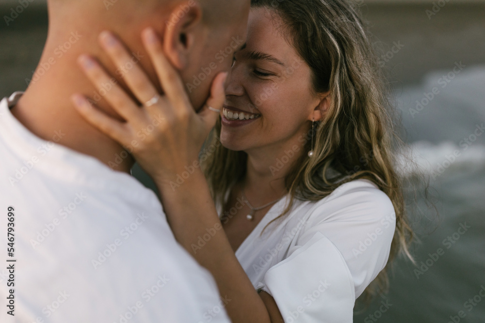 Close up of young couple hugging and kissing in water Close up of young couple hugging and kissing in water