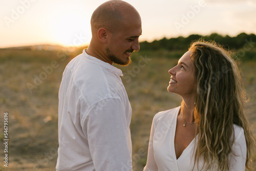 Romantic couple walking together at the beach photo