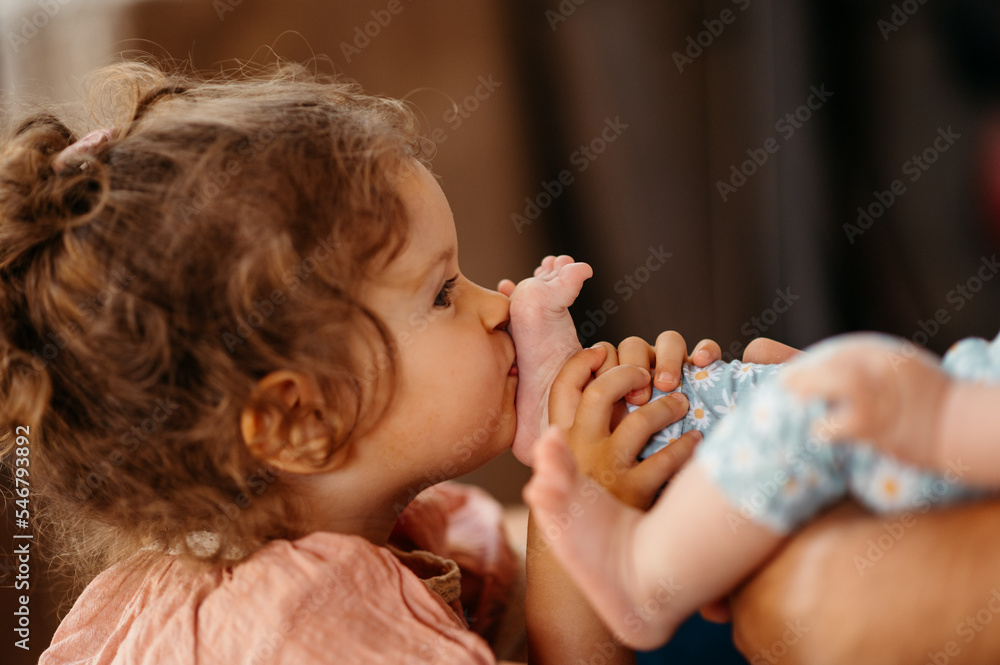 Girl kiss baby foot. Girl kiss baby foot.