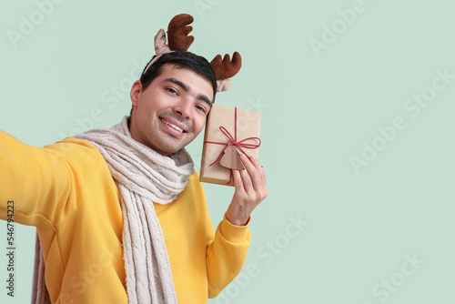 Happy young man in reindeer...