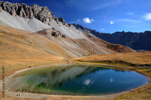 Souliers lake located above Izoard Pass (after one hour hike from Casse deserte car park), with reflections of mountain range and Autumn colors, Queyras Regional Natural Park, Southern Alps, France photo