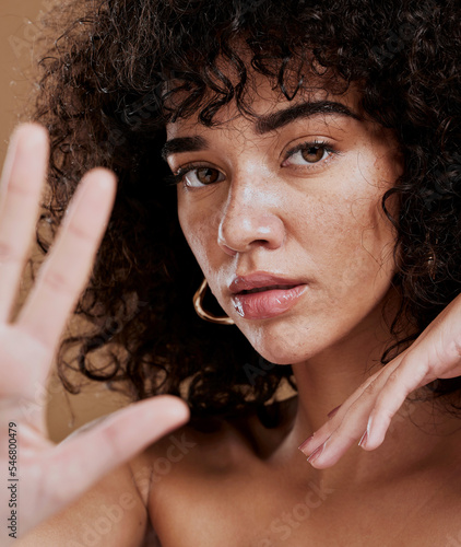 Hand, portrait and woman in studio for skincare, beauty and wellness, sexy and attitude. Face, skin and girl model showing stop hand sign, saying no to ageing and satisfied with natural product
