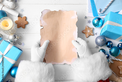 Santa claus hands holding b...
