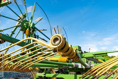Close-up of a tedder against blue sky photo
