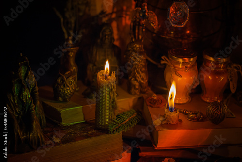 Illustration of magical stuff....candle light, magic wand, book of spells dark background, wizarding school, mystical aesthetic