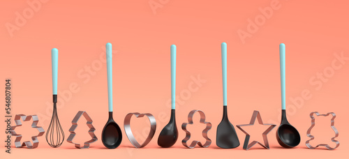 Set of metal cookie cutters and wooden kitchen utensils on coral background