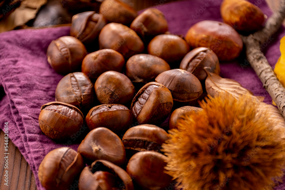 Chestnuts on a wooden table.
Tasty chestnuts image. Chestnuts on a wooden table.
Tasty chestnuts image.