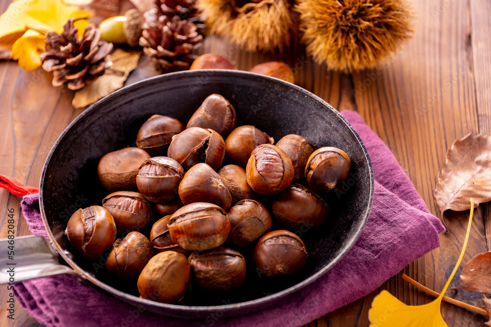 Chestnuts on a wooden table.
Tasty chestnuts image. Chestnuts on a wooden table.
Tasty chestnuts image.