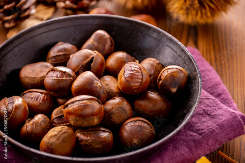 Chestnuts on a wooden table. Tasty chestnuts image.