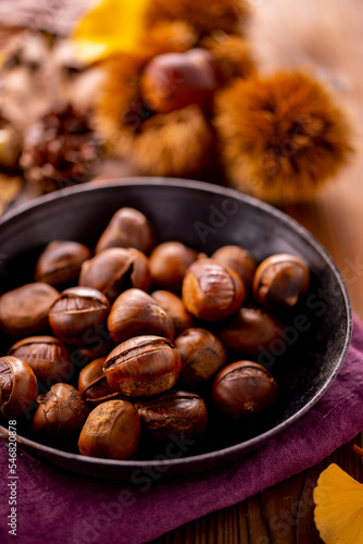 Chestnuts on a wooden table. Tasty chestnuts image.