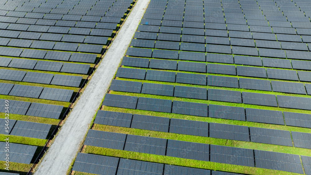 Aerial view of solar farm. Solar power for green energy. Sustainable resources. Solar cell panels use sun light as a source to generate electricity. Photovoltaics or PV. Sustainable renewable energy. Aerial view of solar farm. Solar power for green energy. Sustainable resources. Solar cell panels use sun light as a source to generate electricity. Photovoltaics or PV. Sustainable renewable energy.
