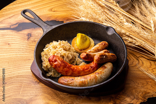 German sausages with sauerkraut and mustard photo