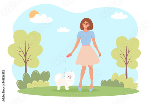 Woman walking with a white spitz dog in a park. Outdoor activity, love pets concept.