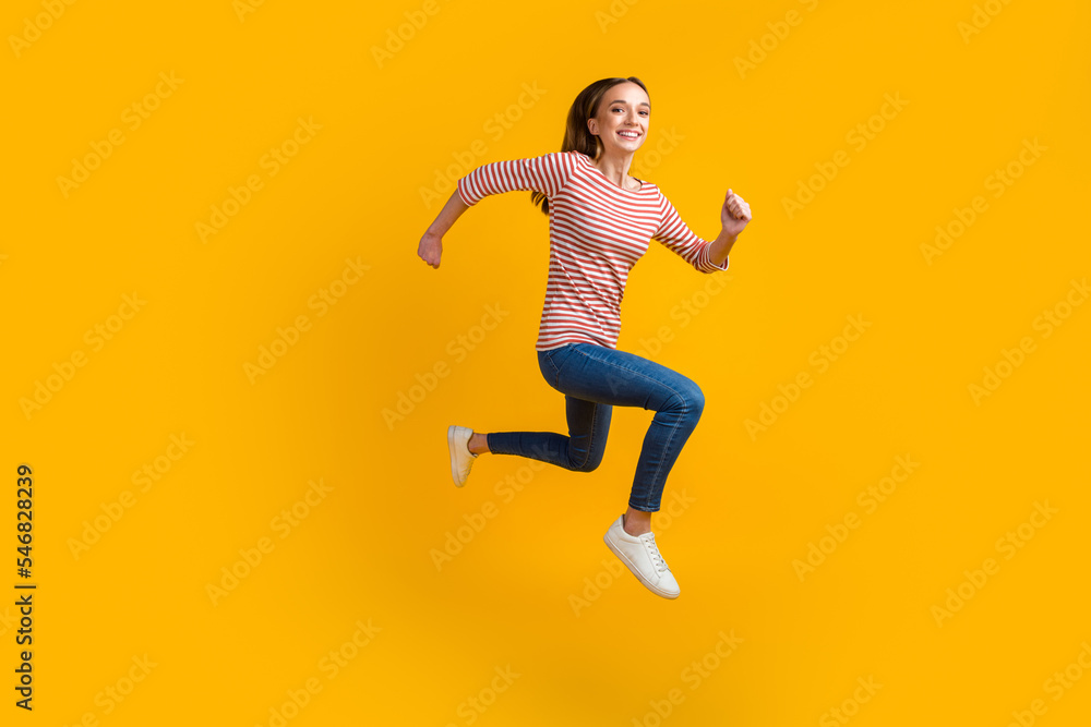Photo of smiling cheerful young brunette woman 20s years old jumping running isolated on bright color background studio