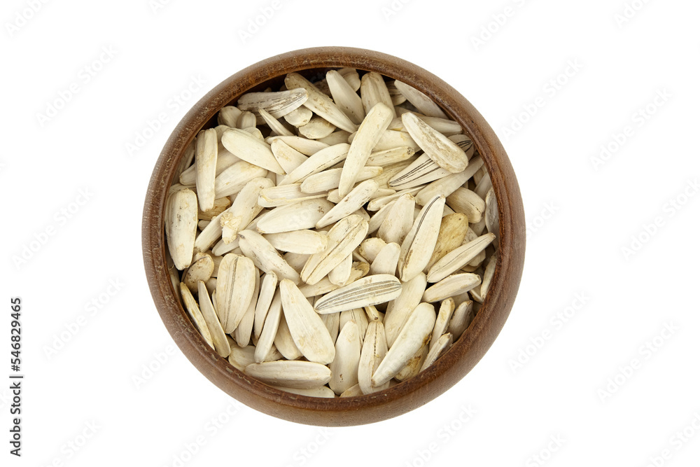 White sunflower seeds in wooden bowl isolated on white White sunflower seeds in wooden bowl isolated on white