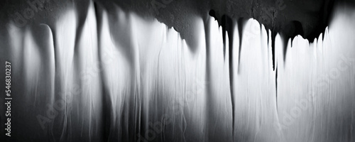Breaking white wall on black background