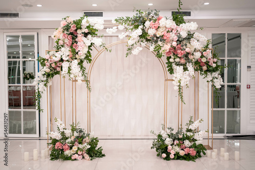 Arch for the wedding ceremony, decorated with white and pink flowers. photo