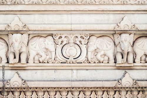Photography Stone elephants carvings and the facade detail of a Hindu temple in India