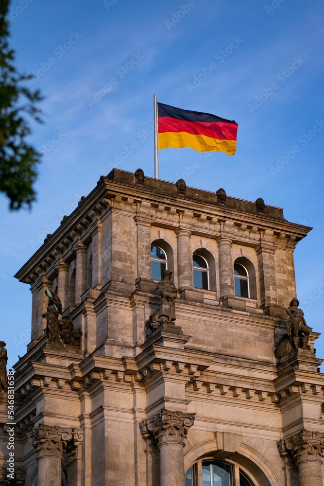 Naklejka premium German flag over Reichstag Building in Berlin