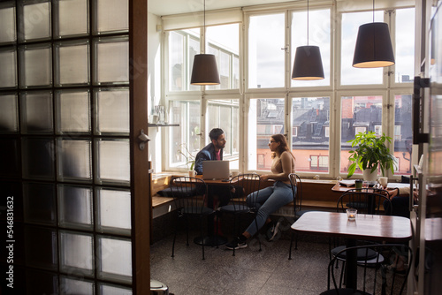 Coworkers talking in office break room