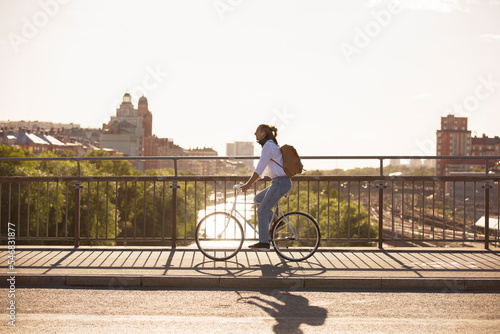 Man riding bicycle on bridge photo