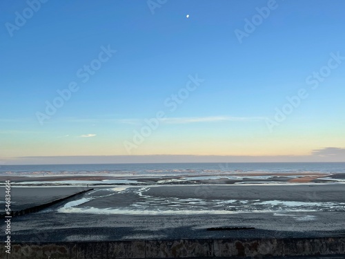 Aerial view of Cleveleys Beach at sunrise with waves crashing onto the beach.  photo