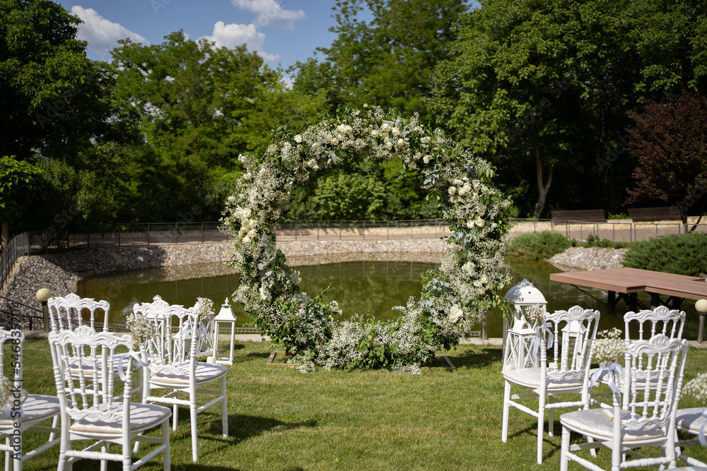 Round flower arch. Circle wedding ceremony arch. Trend. Outside ceremony