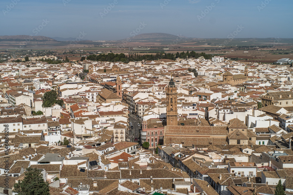 the city of Antequera. tight buildings, white houses, monuments, churches view from the castle hill. Peña de los Enamorados hills and rock in the background