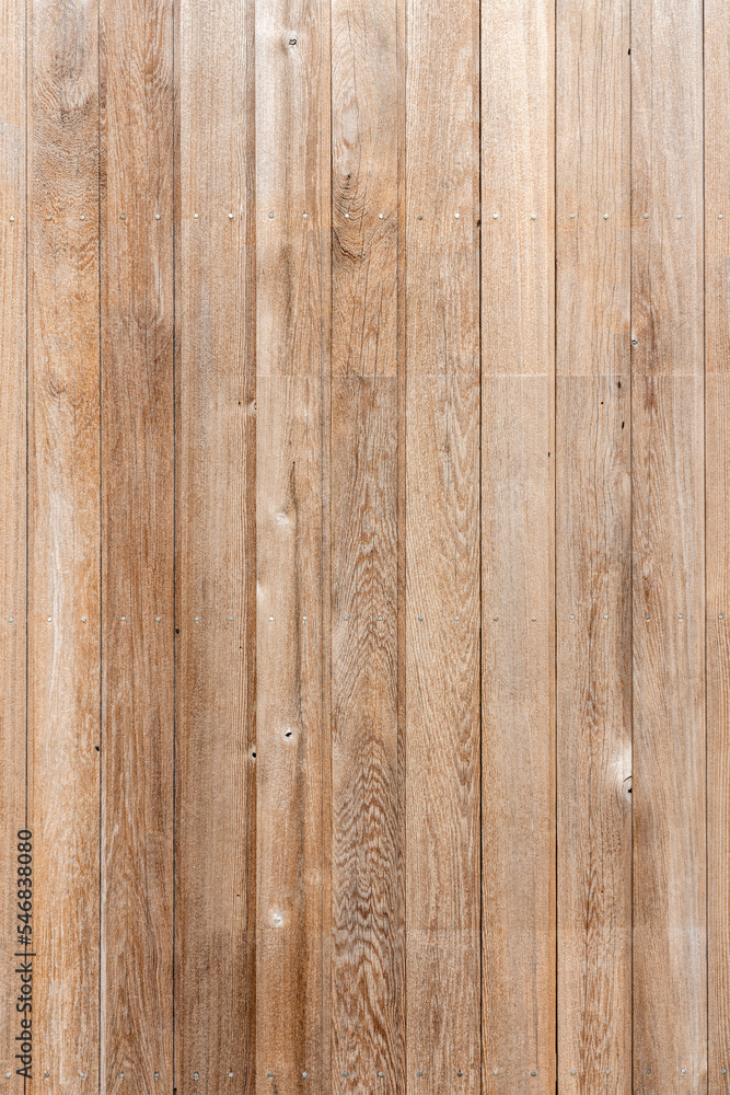 Fototapeta premium New modern brown wooden fence panel background with rough knotted grain timber texture, stock photo image