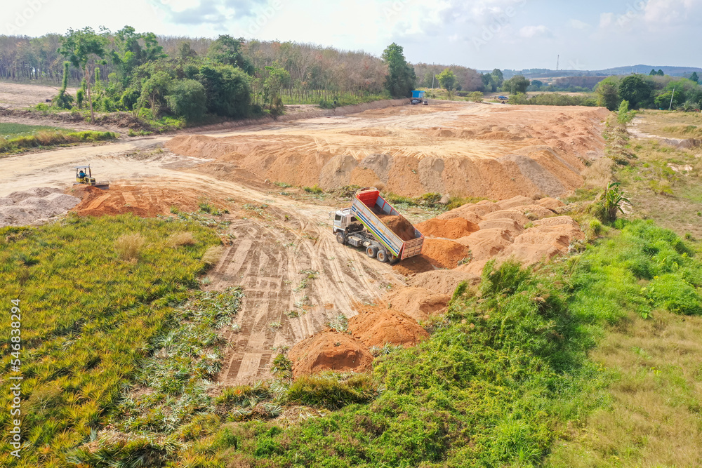 Aerial view of excavator at construction site. Aerial drone Photo a construction site. Heavy equipment is grading the land Aerial view of excavator at construction site. Aerial drone Photo a construction site. Heavy equipment is grading the land