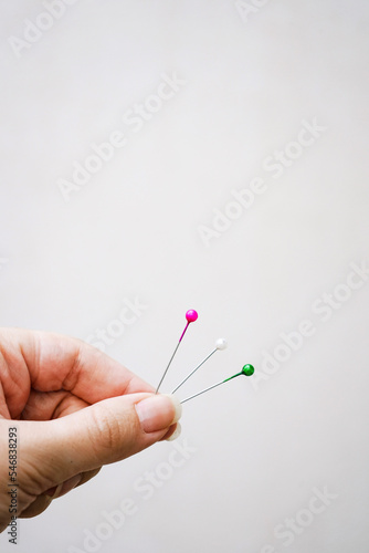 Conceptual image about choice with color pins against beige background