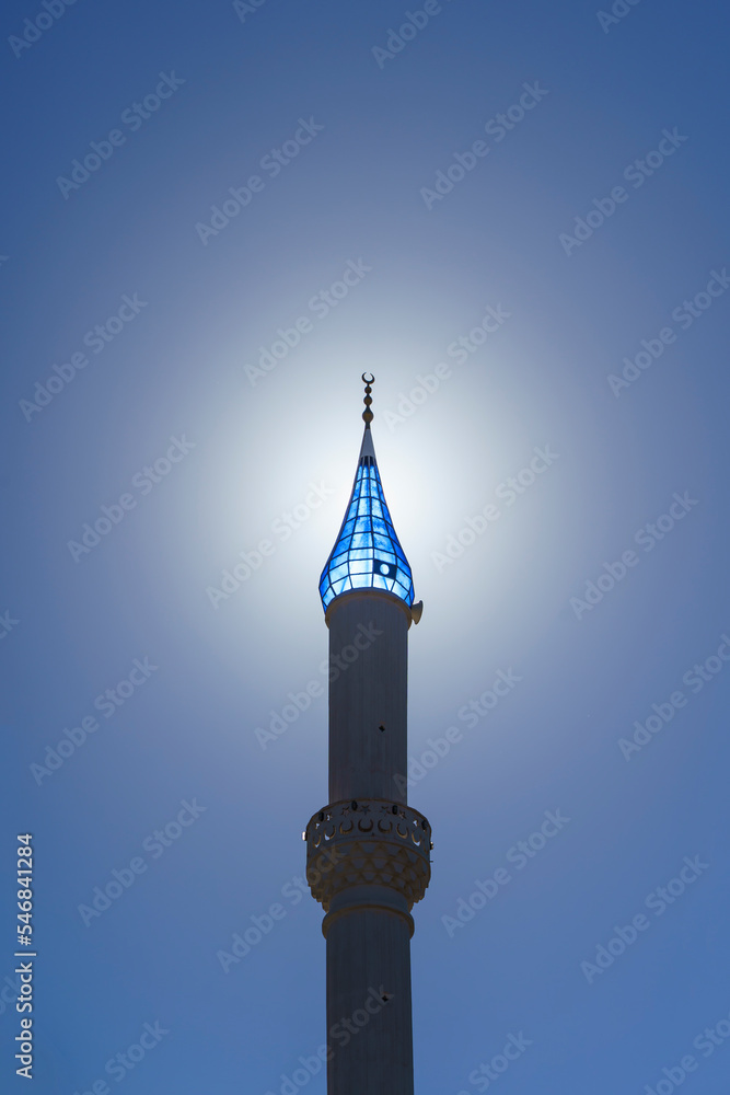 Architecture of an Islamic mosque in Turkey against the backdrop of a sunny sky background. Minaret of a Muslim mosque with a blue dome Architecture of an Islamic mosque in Turkey against the backdrop of a sunny sky background. Minaret of a Muslim mosque with a blue dome