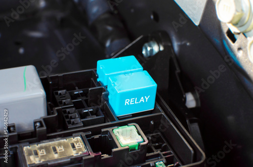 The car electronic relay in slot of relay socket box on engine compartment, automotive parts concept