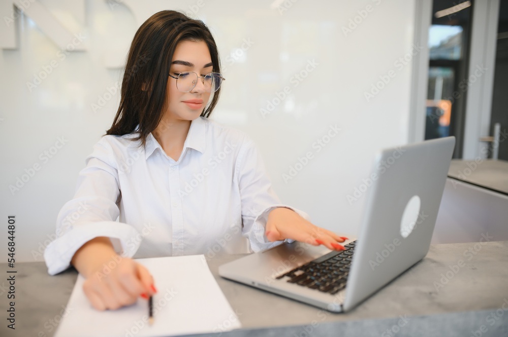 friendly young woman behind the reception desk administrator friendly young woman behind the reception desk administrator