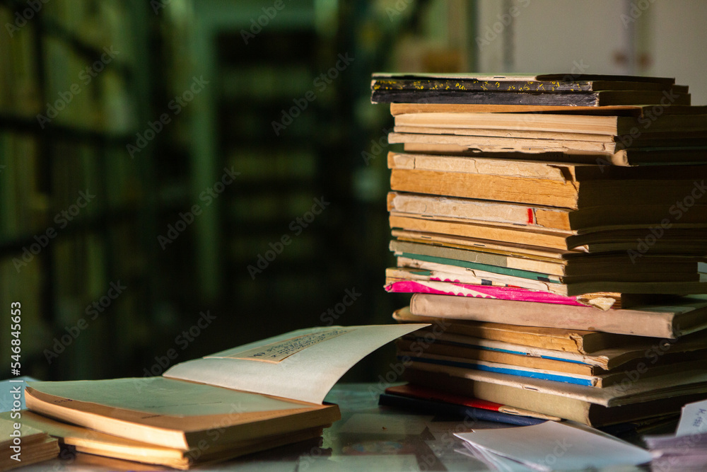 Very old books sitting on the shelves in the library. Books as a symbol of knowledge. Very old books sitting on the shelves in the library. Books as a symbol of knowledge.