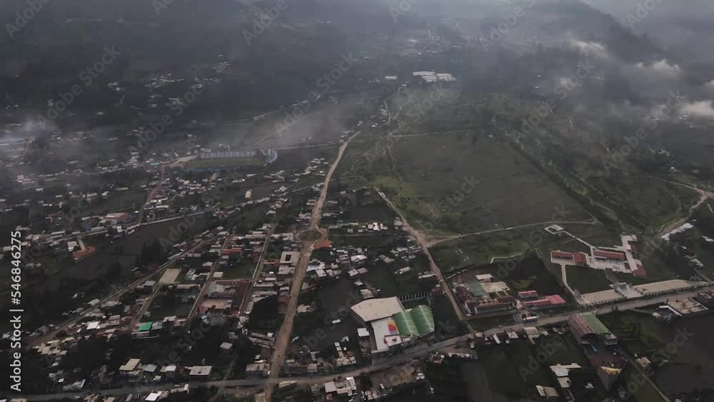 A revealing misty drone shot of Huascaran snowy peak next to a mountain in the city of Yungay in the Andes of Peru A revealing misty drone shot of Huascaran snowy peak next to a mountain in the city of Yungay in the Andes of Peru
