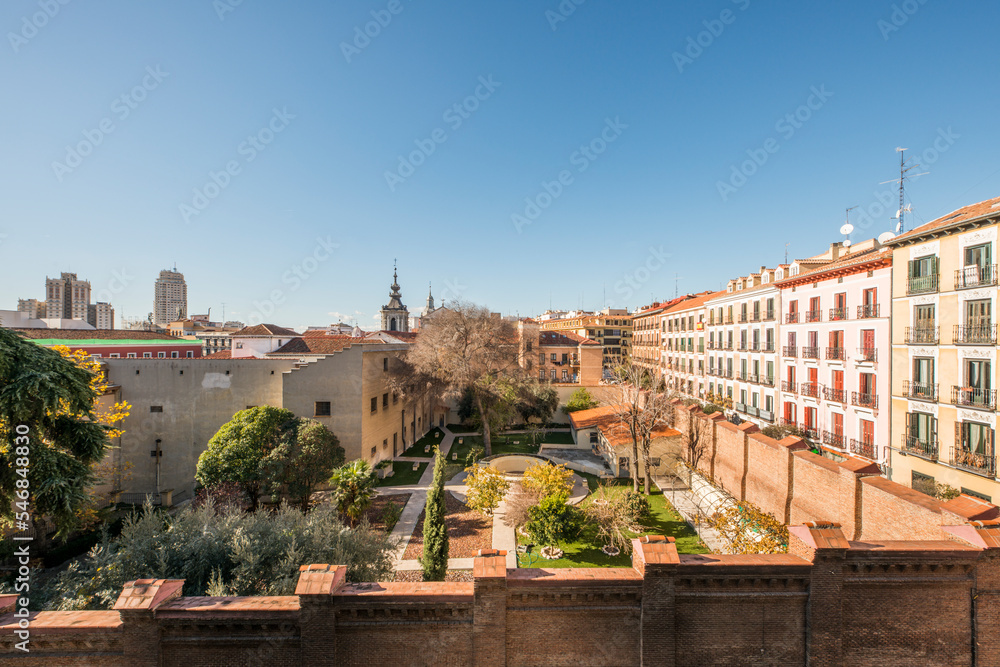 View of an area of the Catholic church bounded by a large brick wall in the downtown area of the city of Madrid