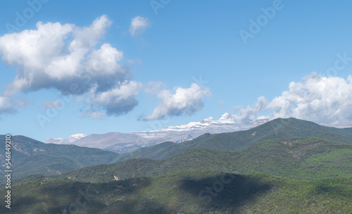 Clouds above rolling green mountains photo
