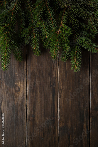 Christmas decorations. Fir branches on a wooden background with copy space. Top view.