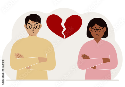 Sad man and woman next to a broken red heart. Broken heart