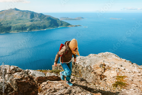 Woman trail running in mountains Norway hiking active travel adventure vacations outdoor trip healthy lifestyle eco tourism photo