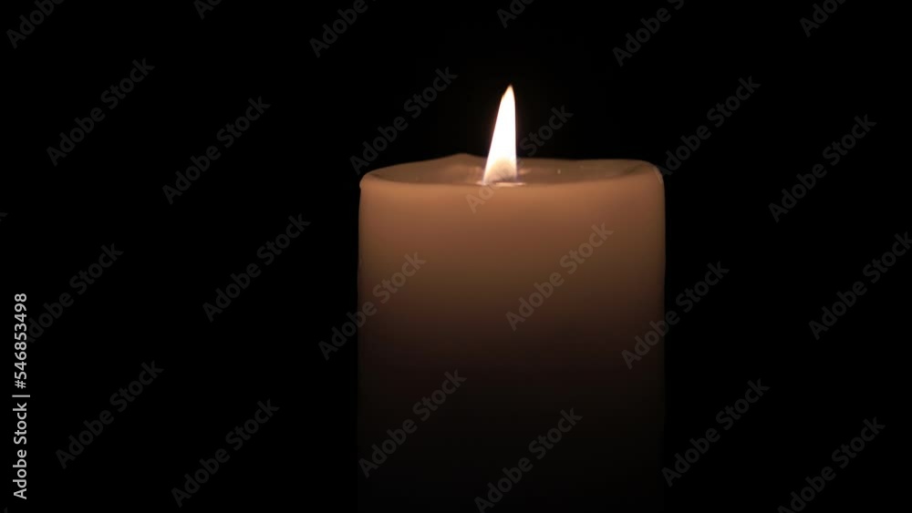 burning candle on the black backgrounds burning candle on the black backgrounds